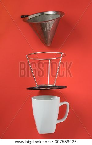 White Coffee Mug On Red Background. Metal Pour Over Drip Cone Pulled Apart.