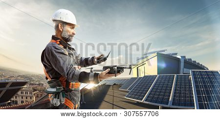 Happy Engineer Using Drone For Cheking Solar Station. In Roof