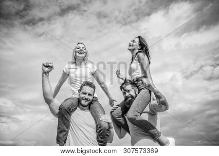 Twice Fun On Double Date. Couples In Love Having Fun. Men Carry Girlfriends On Shoulders. Summer Vac