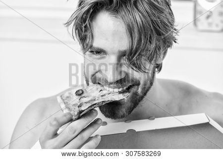 Guy Holds Pizza Box Sit Bed In Bedroom Or Hotel Room. Hungry Young Man In Underwear Sits At Home On 