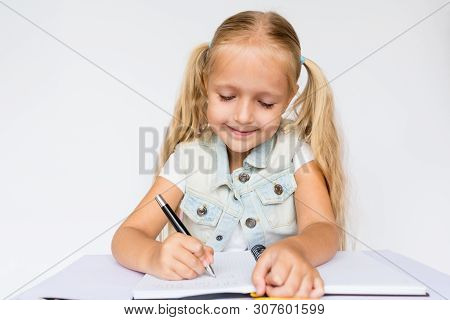 Back To School And Happy Time. Children Holding Pen And Writting In Notebook On White Background. Ki