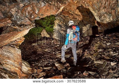 Young Speleologist Is Exploring A Dark Cave
