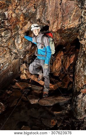 Young Speleologist Is Exploring A Dark Cave