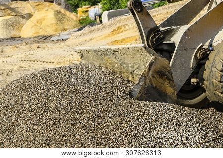 Tractor Collects Scoop With  Gravel. Excavator Extracts Sand And Gravel For  Concrete Mix.