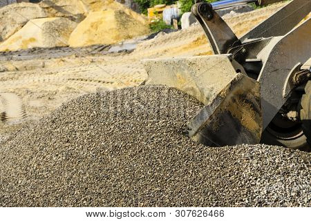 Tractor Collects Scoop With  Gravel. Excavator Extracts Sand And Gravel For  Concrete Mix.