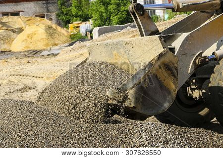 Tractor Collects Scoop With  Gravel. Excavator Extracts Sand And Gravel For  Concrete Mix.