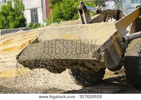 Tractor Collects Scoop With  Gravel. Excavator Extracts Sand And Gravel For  Concrete Mix.