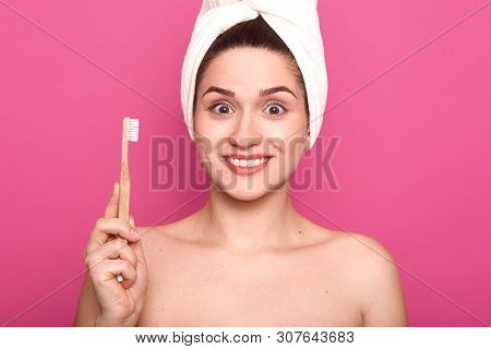 Portrait Of Smiling Pretty Woman With Astonished Facial Expression, Holds Toothbrush Isolated Over P