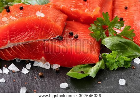 Fresh Raw Copper River Sockeye Salmon Fillets On Natural Stone With Herbs And Seasoning