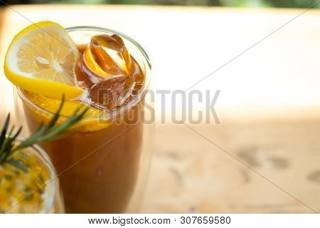 Glass Of Espresso Shot Mixed With Orange Juice And Topped With Fresh Sliced Orange