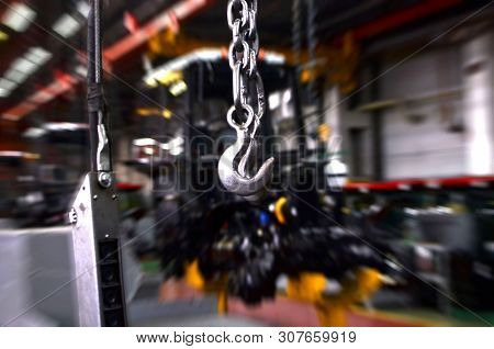 Crane Hook Of The Overhead Crane In The Workshop Of An Industrial Plant For The Production Of Tracto
