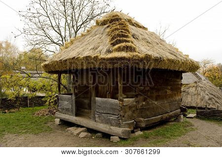 Old Village House With Thatched Roof. Traditional Ukrainian Architecture