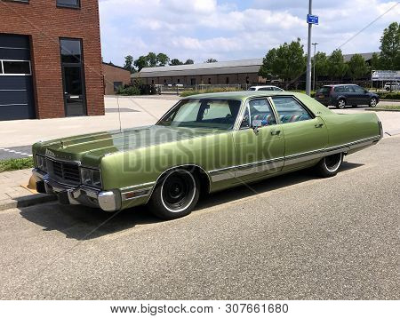 Woerden, The Netherlands - June 22, 2019: Green Chrysler New Yorker Parked By The Side Of The Road. 