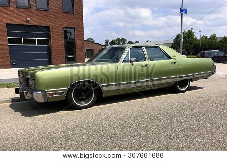 Woerden, The Netherlands - June 22, 2019: Green Chrysler New Yorker Parked By The Side Of The Road. 
