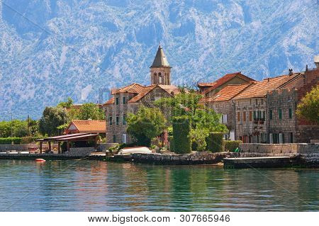 Small Seaside Village In The Background Of The Mountains. Montenegro, Adriatic Sea. View Of Bay Of K