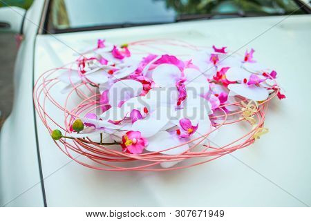 Beautiful Decor Of A White Wedding Limousine With White Orchids