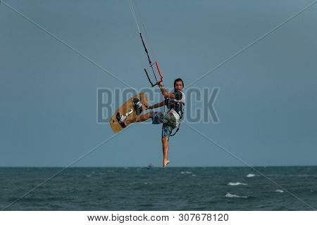 Kitesurfing on the waves of the sea in Mui Ne beach, Phan Thiet, Binh Thuan, Vietnam. Kitesurfing, Kiteboarding action photos Kitesurfer In action