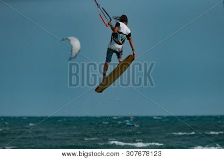 Kitesurfing on the waves of the sea in Mui Ne beach, Phan Thiet, Binh Thuan, Vietnam. Kitesurfing, Kiteboarding action photos Kitesurfer In action