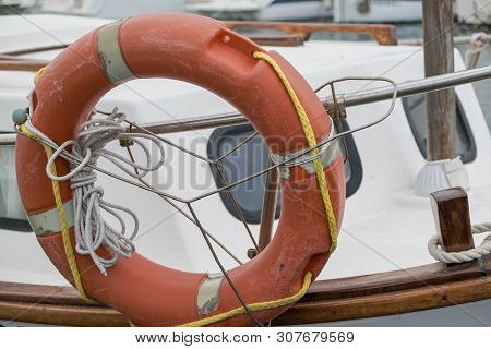 A Lifebuoy, Ring Buoy, Lifering, Lifesaver, Life Donut, Life Preserver On The Boat. Lifebuoy Tied To