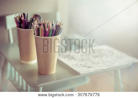 Colored Pencils Are On The High Chair. Warm And Cozy Place For Drawing And Creativity Kids. Close-up