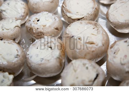 Mushroom Caps Stuffed With Chive Cream Cheese On A Foil Container