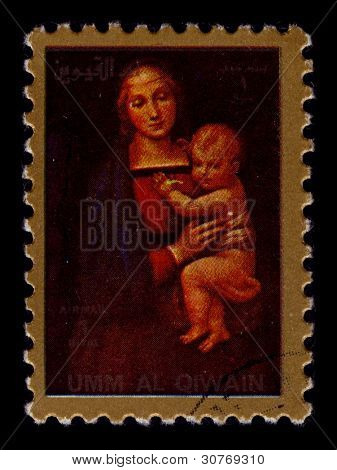 UMM-AL-QIWAIN-CIRCA 1990:A timbre imprimé en UMM-AL-QIWAIN montre l'image de la Vierge et l'enfant, vers 19