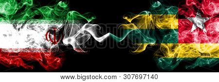 Iran Vs Togo, Togolese Smoky Mystic States Flags Placed Side By Side. Thick Colored Silky Smokes Fla