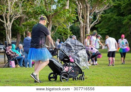 Mackay, Queensland, Australia - June 2019: Unidentified Man Wearing A Blue Skirt Pushing A Pram At T