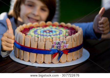 Sweet Preteen Boy, Celebrating His Birhtday With Colorful Cake Outdoors