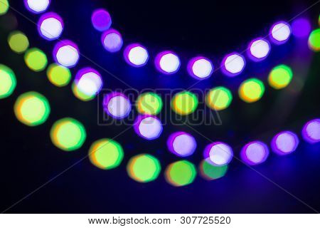 Purple Green Neon Blurry Bokeh Lights. Festive Winter Background