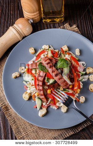 Salad With Grilled Sausage Paprica Cucumber And Croutons