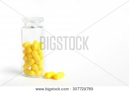 Yellow Capsules From Glass Bottle On White Background. Copyspace For Text. Epidemic, Painkillers, He