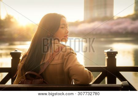 Korean Lady Sit And Relax In Cherry Blossom Park In Seoul City Between Sunrise Time, South Korea, Th