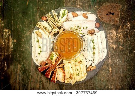 Cheese Plate On The Stone Assortment Of Various Types Of Chees With Nuts, Honey And Berries. Home Ma