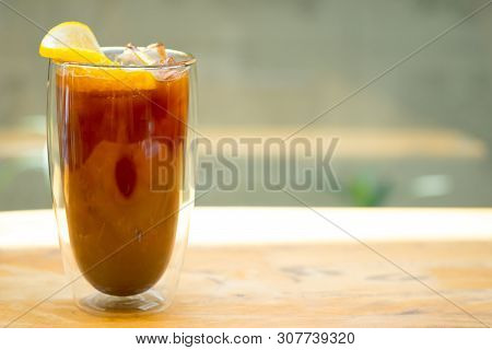 Glass Of Espresso Shot Mixed With Orange Juice And Topped With Fresh Sliced Orange