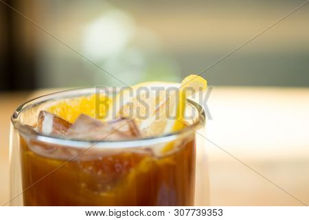 Glass Of Espresso Shot Mixed With Orange Juice And Topped With Fresh Sliced Orange