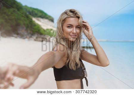 Follow Me Concept. Charming Romantic Tanned Bloned Girlfriend Give Boyfriend Hand Turn Back Smiling 