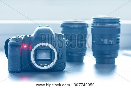 Professional Camera: Reflex Camera With Open Sensor. Lenses In The Background.