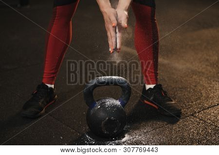 Closeup Of Female Athlete Claping Hands And Getting Ready For Kettlebell Workout At Gym.