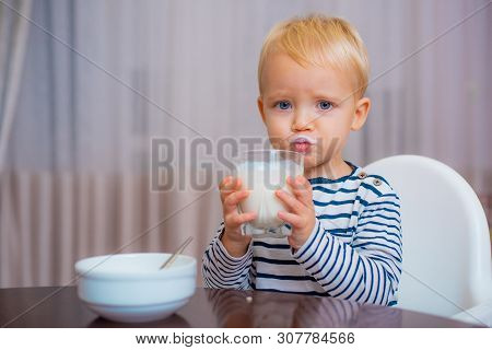 Eat Healthy. Toddler Having Snack. Healthy Nutrition. Drink Milk. Child Hold Glass Of Milk. Kid Cute