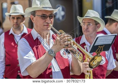 Timisoara,romania-june 16,2019:fanfare Singers, Ethnic Germans, Playing At Musical Instruments.the D
