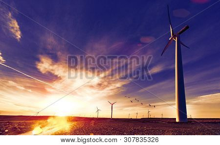 Eolic Park And Wind Mills In Sunset Landscape And Fields.concept Of Engineering And Renewable Energi