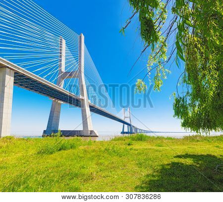 Modern Bridge And Architecture With Nature And Blue Sky.vasco Da Gama Bridge In Lisbon,portugal.