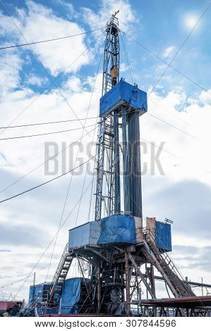 Drilling Rig In Oil Field For Drilled Into Subsurface In Order To Produced Crude. Petroleum Industry