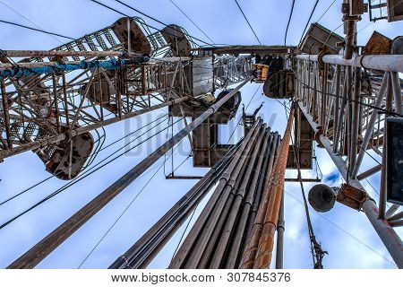 Drilling Rig In Oil Field For Drilled Into Subsurface In Order To Produced Crude. Petroleum Industry