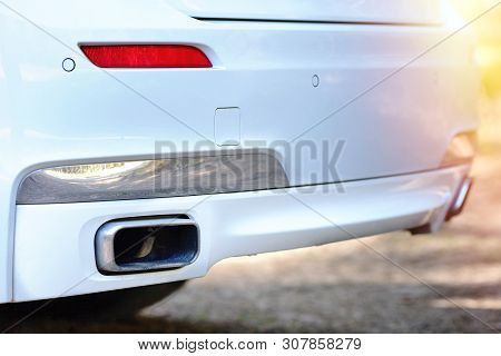 Selective Focus On Parking Sensor Exhaust Pipe Bumper At Rear Of White Luxurious Car Bumper Close Up