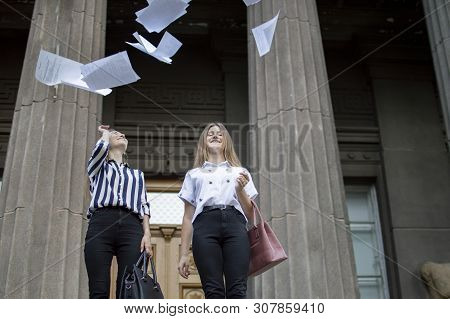 Two Young Happy Students Passed Exams And Leave Home For School, They Run Up The Stairs And Throw Aw
