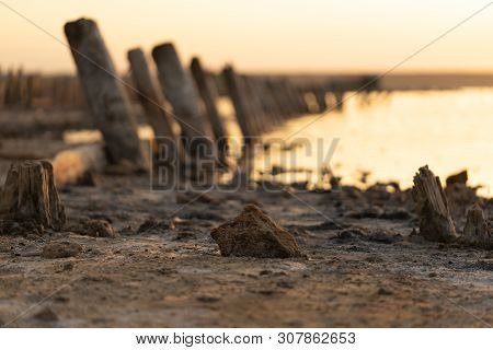Sunset On The Kuyalnik Liman. Odessa. Ukraine. Old Logs Are Visible From The Water - The Remains Of 
