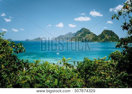 Lonely Yacht Boat In The Sea Bay Near Las Cabanas Beach. Rocky Mountains In Background. El Nido, Pal