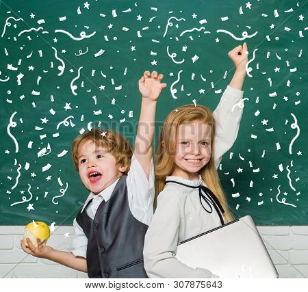 Woohoo. Cheerful Smiling Child At The Blackboard. Schoolchild. Book School And Kids. Classroom. Scho